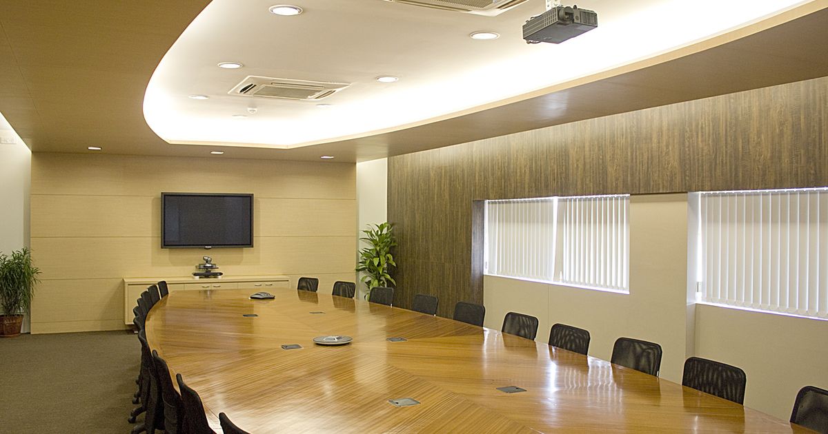Boardroom conference table set for a company board meeting