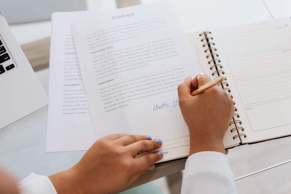 Business professional reviewing and signing legal and tax registration documents