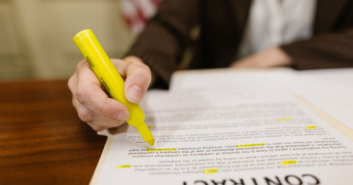 Close-up of a hand reviewing the terms of a business contract