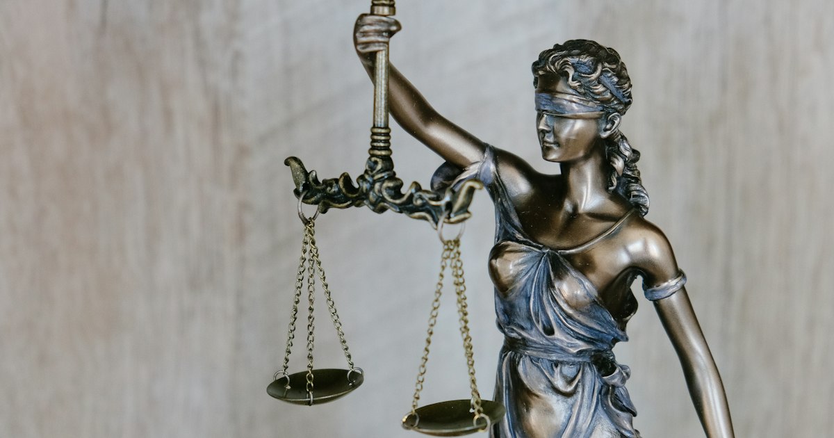 Golden scales of justice on a lawyer's desk representing legal fairness and dispute resolution